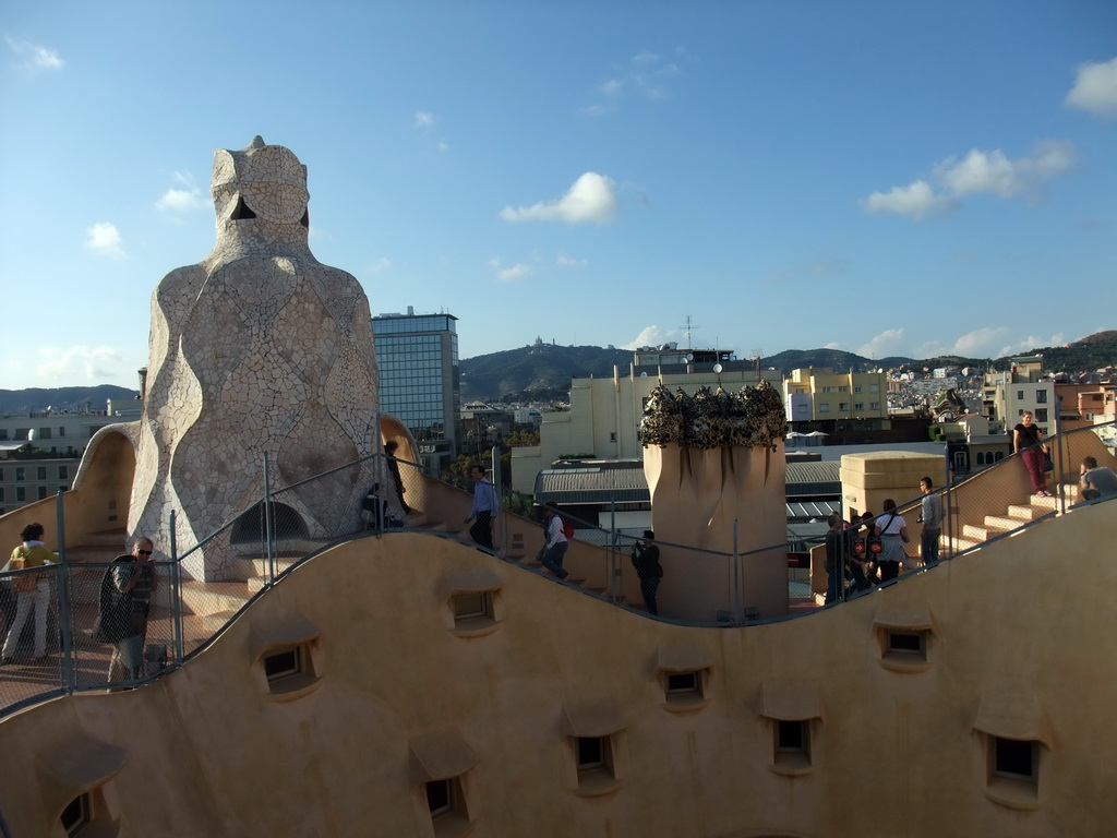 The roof of the La Pedrera building with chimneys and ventilation towers, with a view on Mount Tibidabo and the Temple Expiatori del Sagrat Cor church