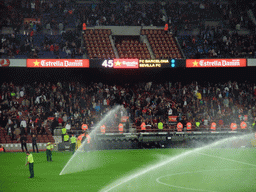 Scoreboard and field being sprayed during halftime at the football match FC Barcelona - Sevilla FC in the Camp Nou stadium