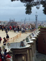 The southeast side of the Square of Nature at Park Güell, with a view on the tower of the west entrance building and the city center with the Sagrada Família church