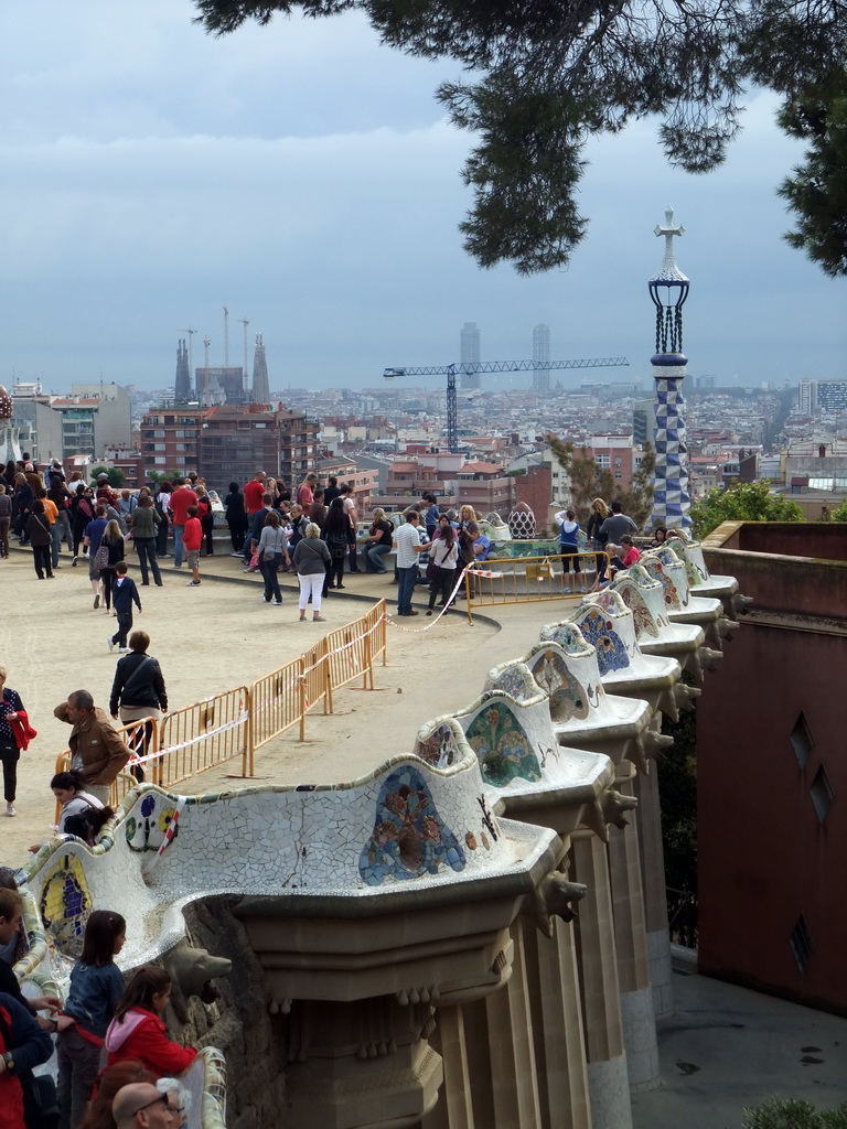 The southeast side of the Square of Nature at Park Güell, with a view on the tower of the west entrance building and the city center with the Sagrada Família church