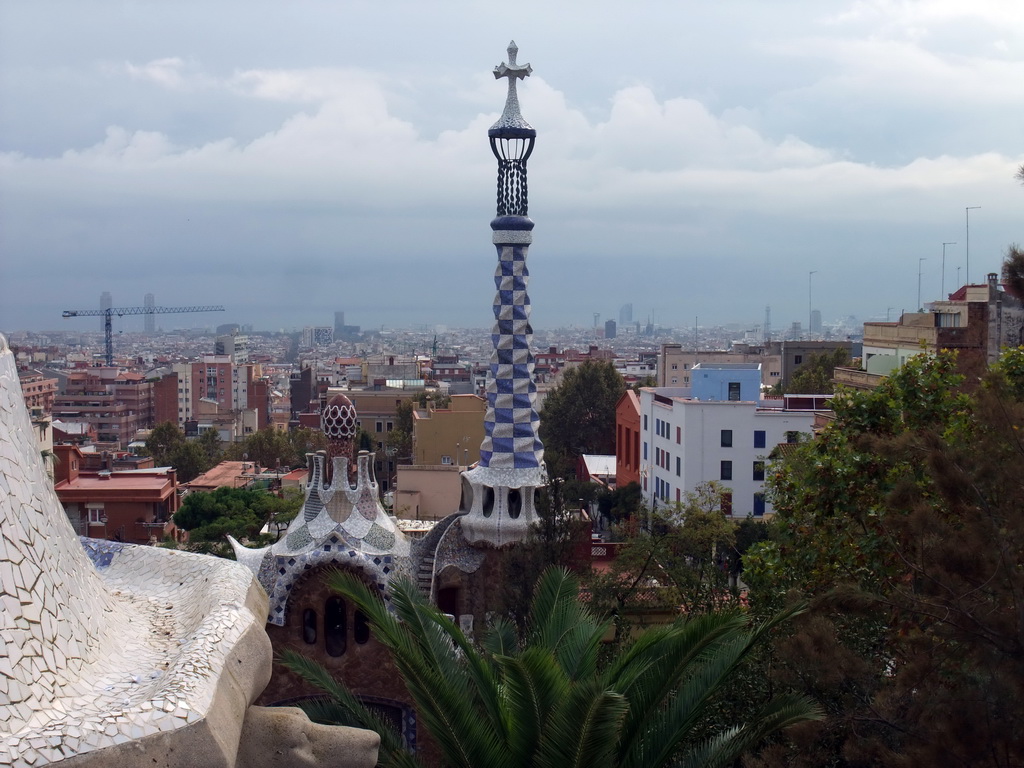 The tower of the west entrance building of Park Güell, with a view on the city center