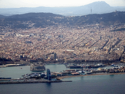 The city center with the Sant Sebastià beach, the Port Vell harbour and the Tibidabo mountain with the Sagrat Cor church, viewed from the airplane from Amsterdam