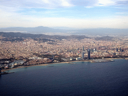 The city center with the Sant Sebastià and La Barceloneta beaches, the Sagrada Família church and the Agbar Tower, viewed from the airplane from Amsterdam