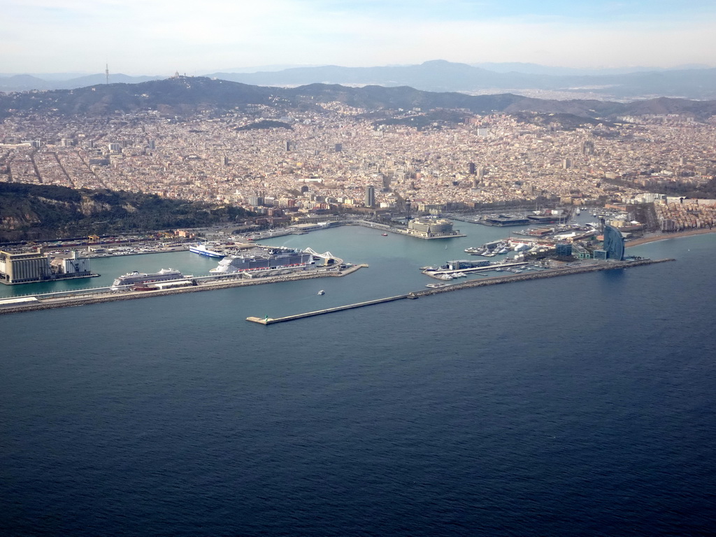 The city center with the Port Vell harbour, the Montjuïc hill and the Tibidabo mountain with the Sagrat Cor church, viewed from the airplane from Amsterdam