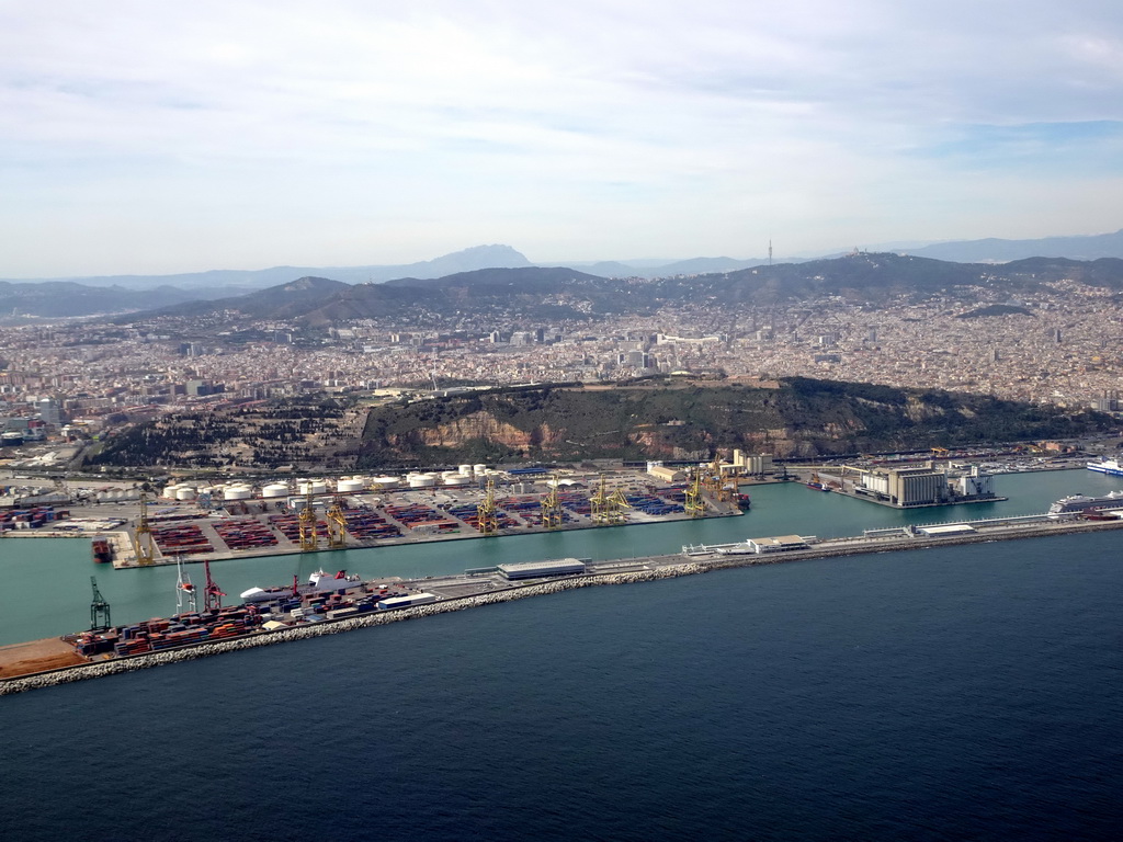 The city center with the Port de Barcelona harbour, the Montjuïc hill and the Tibidabo mountain with the Sagrat Cor church, viewed from the airplane from Amsterdam