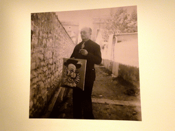 Photograph of Jaume Sabartés with his portrait, at the temporary exhibition `Sabartés by Picasso by Sabartés` at the Picasso Museum