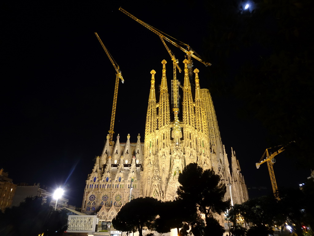 Northeast side of the Sagrada Família church with the Nativity Facade, under construction, viewed from the Plaça de Gaudí park, by night