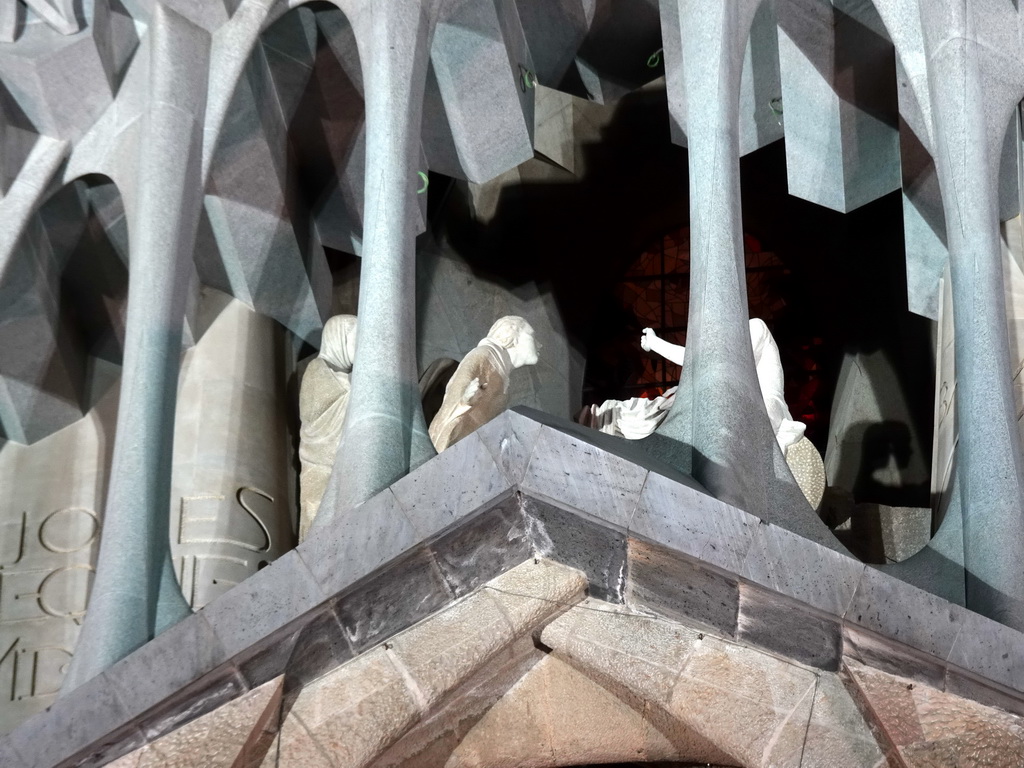 Statues on top of the Portico of the Passion Facade at the southwest side of the Sagrada Família church, viewed from the Plaça de la Sagrada Família square, by night