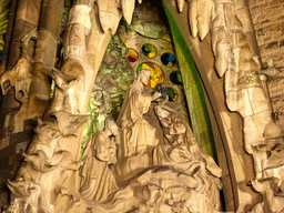 Statues at the Charity Hallway of the Nativity Facade at the northeast side of the Sagrada Família church, viewed from the Carrer de la Marina street, by night