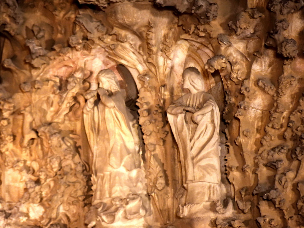 Statues at the Charity Hallway of the Nativity Facade at the northeast side of the Sagrada Família church, viewed from the Carrer de la Marina street, by night