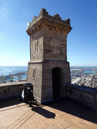 The southwest tower of the Montjuïc Castle at the southeast side of the Montjuïc hill, with a view on the Port de Barcelona harbour