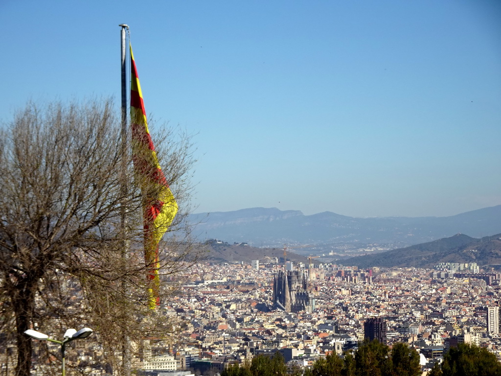 Catalan flag at the Santa Amàlia Bastion of the Montjuïc Castle at the southeast side of the Montjuïc hill and the city center with the Sagrada Família church, viewed from the Terrace