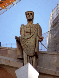Statue on top of the Portico of the Passion Facade at the southwest side of the Sagrada Família church, viewed from the Plaça de la Sagrada Família square