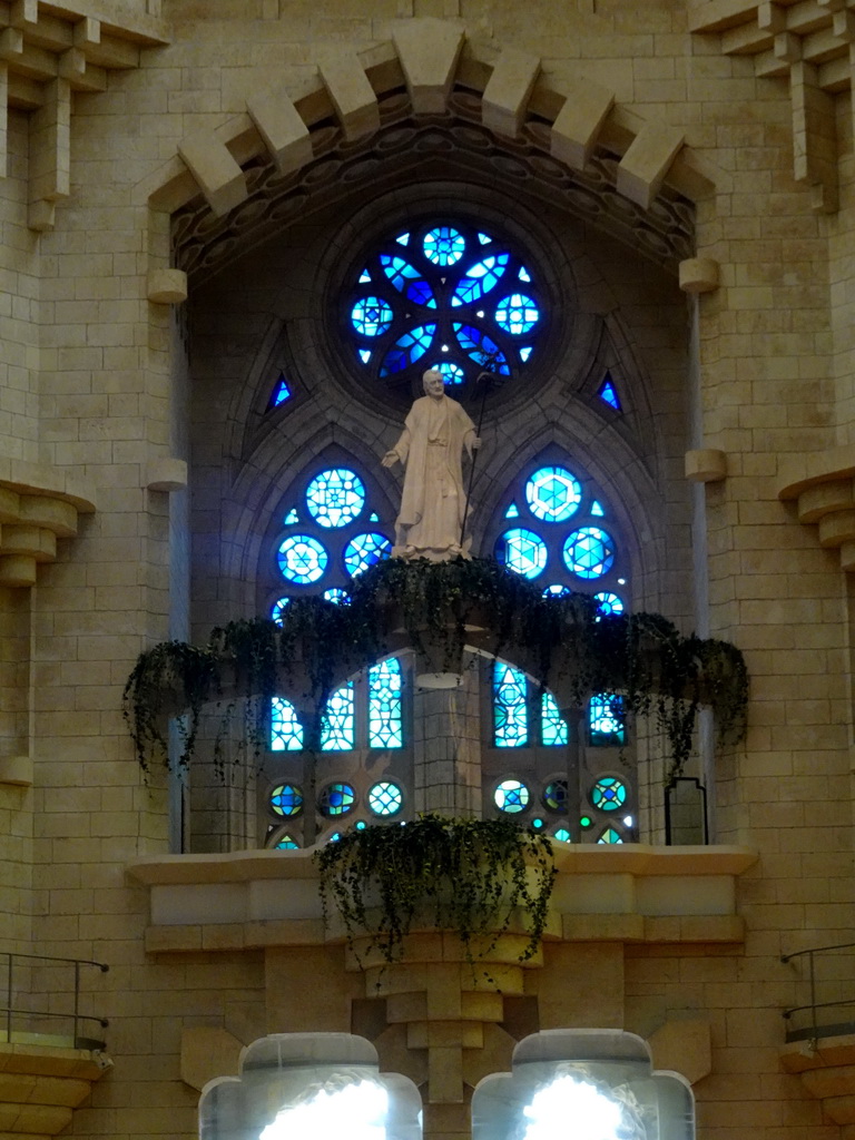 Statue and stained glass windows at the northeast transept of the Sagrada Família church