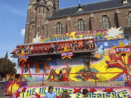 Funfair attraction in front of the south side of the Heilige Maria Hemelvaartkerk church at the Brigidastraat street