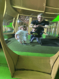 Tim, Max and Max`s friend in a distorting mirror at the Rainforest Mirror Maze attraction at the funfair at the Brigidastraat street