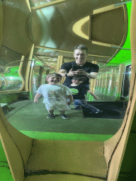 Tim, Max and Max`s friend in a distorting mirror at the Rainforest Mirror Maze attraction at the funfair at the Brigidastraat street