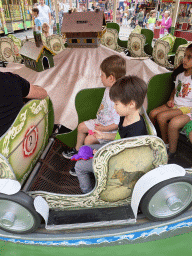 Max and his friend at a carousel at the funfair at the Brigidastraat street