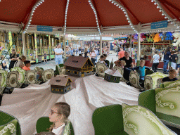 Max and his friend at a carousel at the funfair at the Brigidastraat street