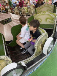 Max and his friend at a carousel at the funfair at the Brigidastraat street