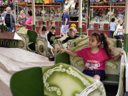 Max and his friend at a carousel at the funfair at the Brigidastraat street