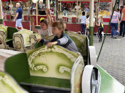 Max and his friend at a carousel at the funfair at the Brigidastraat street