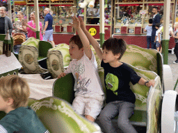 Max and his friend at a carousel at the funfair at the Brigidastraat street