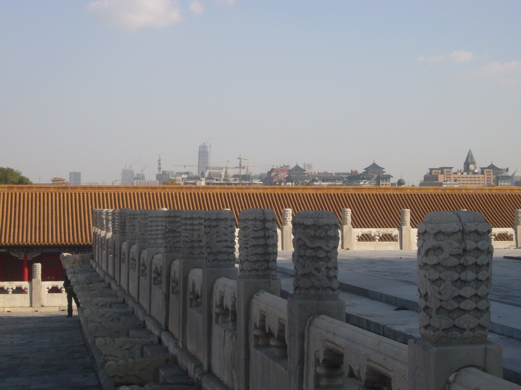 Skyscraper and other buildings in the city center, viewed from the front of the Hall of Complete Harmony at the Forbidden City