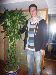 Tim with a plant in the Beijing Shanshui Hotel