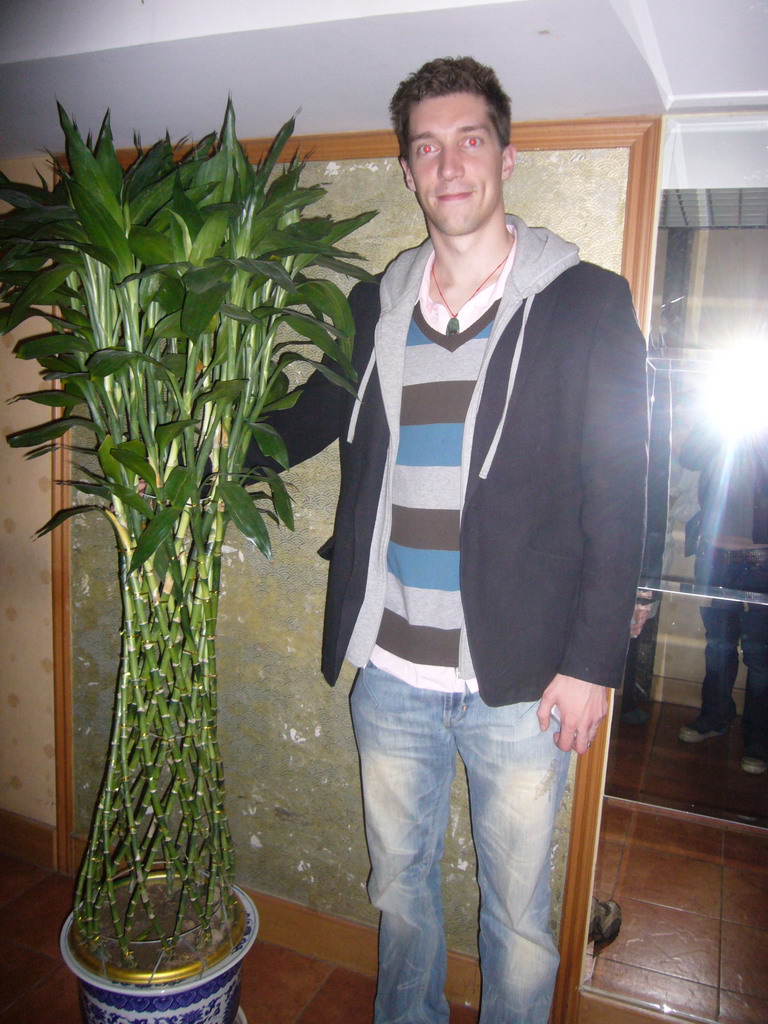 Tim with a plant in the Beijing Shanshui Hotel
