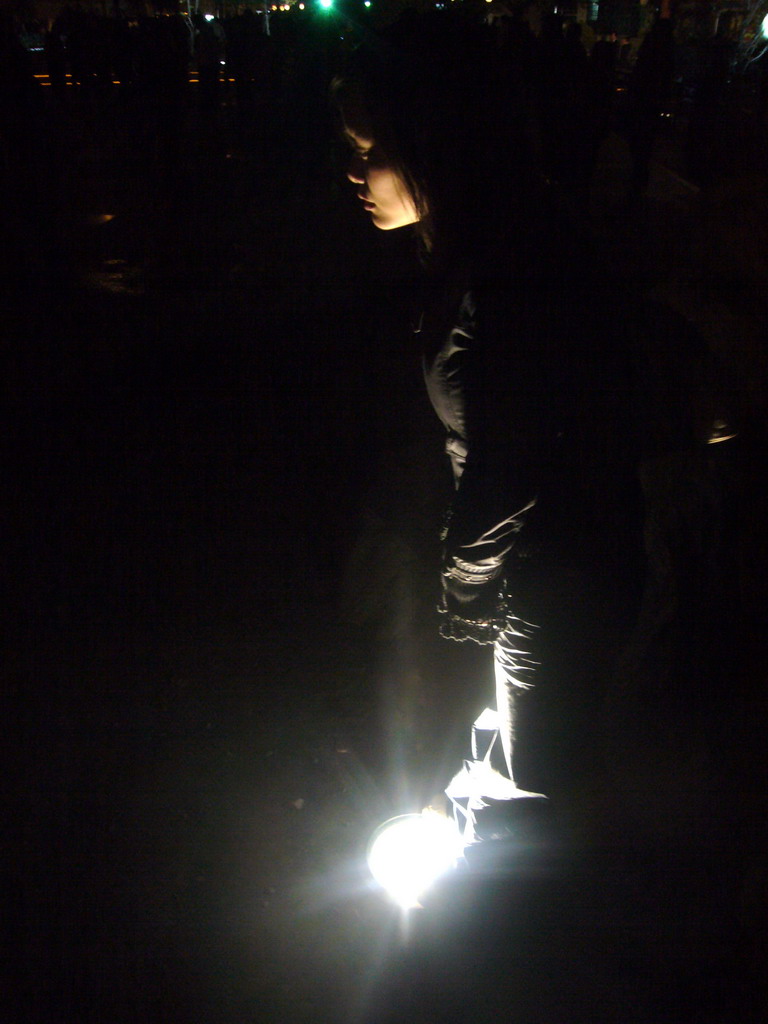 Miaomiao with a light in the ground at the restaurants and pubs at Beihai Lake, by night