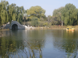 Lake with a bridge and boat at the east side of the Old Summer Palace