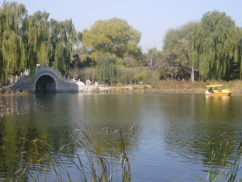 Lake with a bridge and boat at the east side of the Old Summer Palace