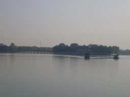 Boats on Kunming Lake, the Seventeen-Arch Bridge and South Lake Island with the Hall Of Embracing The Universe at the Summer Palace, viewed from the Gate of Dispelling Clouds