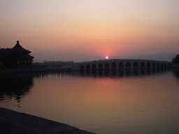 Kunming Lake, the Pavilion of Broad View and the Seventeen-Arch Bridge at the Summer Palace, viewed from the East Causeway, at sunset