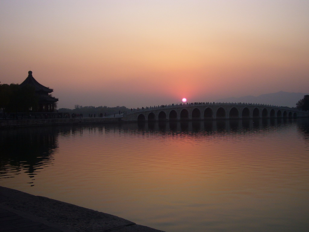 Kunming Lake, the Pavilion of Broad View and the Seventeen-Arch Bridge at the Summer Palace, viewed from the East Causeway, at sunset
