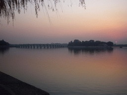Kunming Lake, the Pavilion of Broad View, the Seventeen-Arch Bridge and South Lake Island at the Summer Palace, viewed from the East Causeway, at sunset
