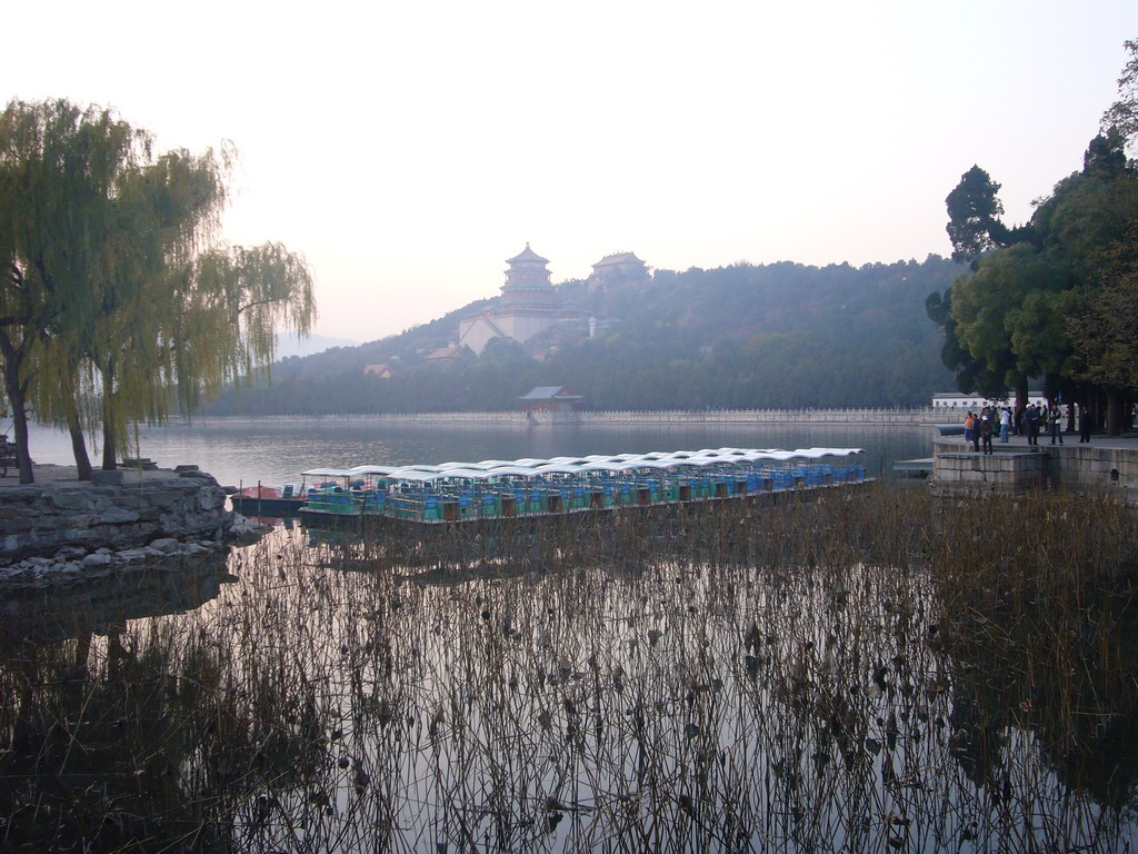 Boats at the east side of Kunming Lake and Longevity Hill with the Tower of Buddhist Incense and the Hall of the Sea of Wisdom at the Summer Palace, viewed from the East Causeway, at sunset