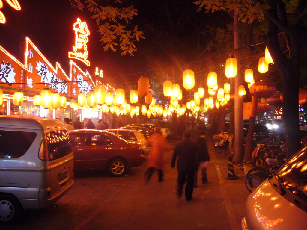 Street with restaurants in the city center, by night