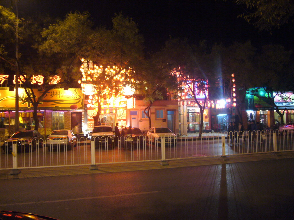 Street with restaurants in the city center, by night