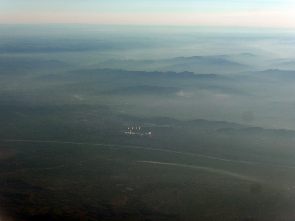 Factory, river and mountains on the west side of the city, viewed from the airplane from Amsterdam