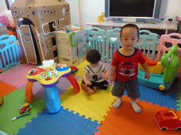 Max and his second cousin playing with toys in the apartment of Miaomiao`s cousin