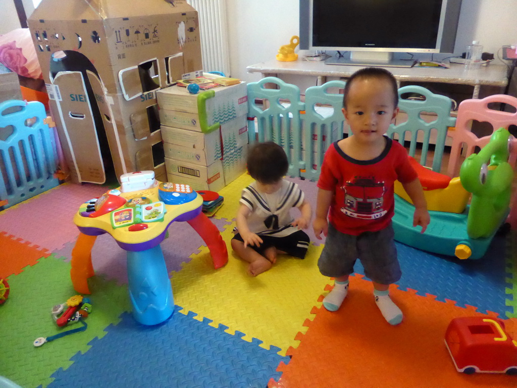 Max and his second cousin playing with toys in the apartment of Miaomiao`s cousin