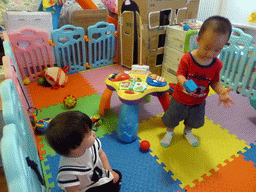 Max and his second cousin playing with toys in the apartment of Miaomiao`s cousin