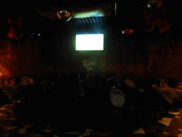 TV screen with the EURO 2016 soccer match Germany vs. Italy and drum set in a pub at Hufang Road