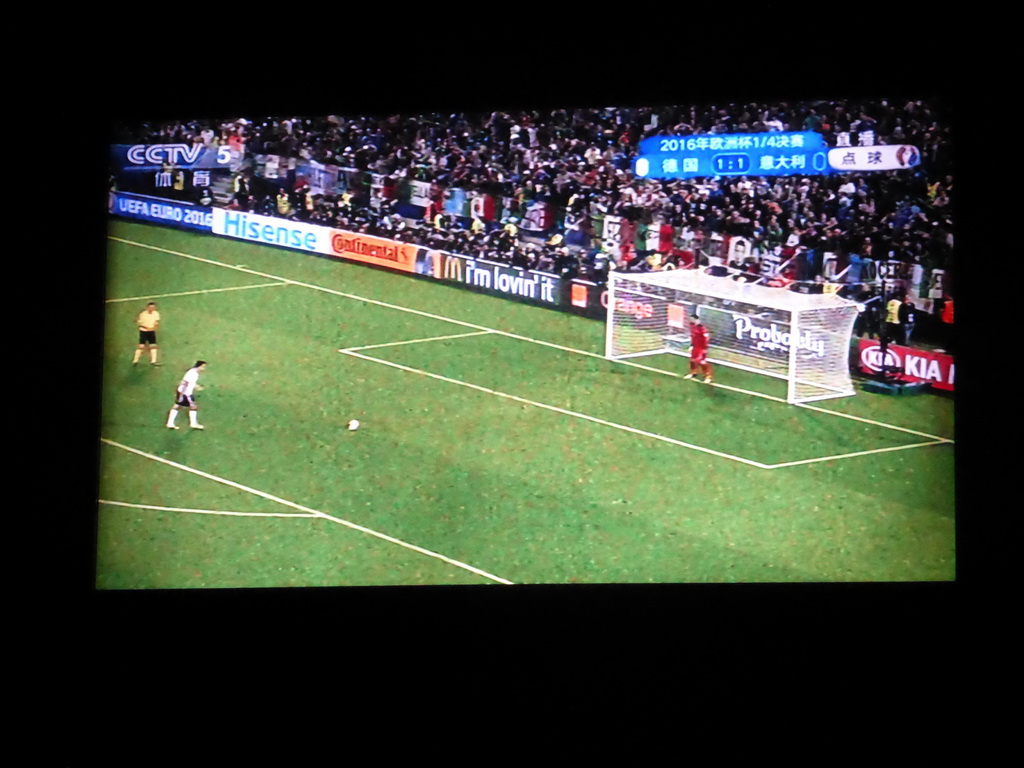 TV screen with the EURO 2016 soccer match Germany vs. Italy in a pub at Hufang Road