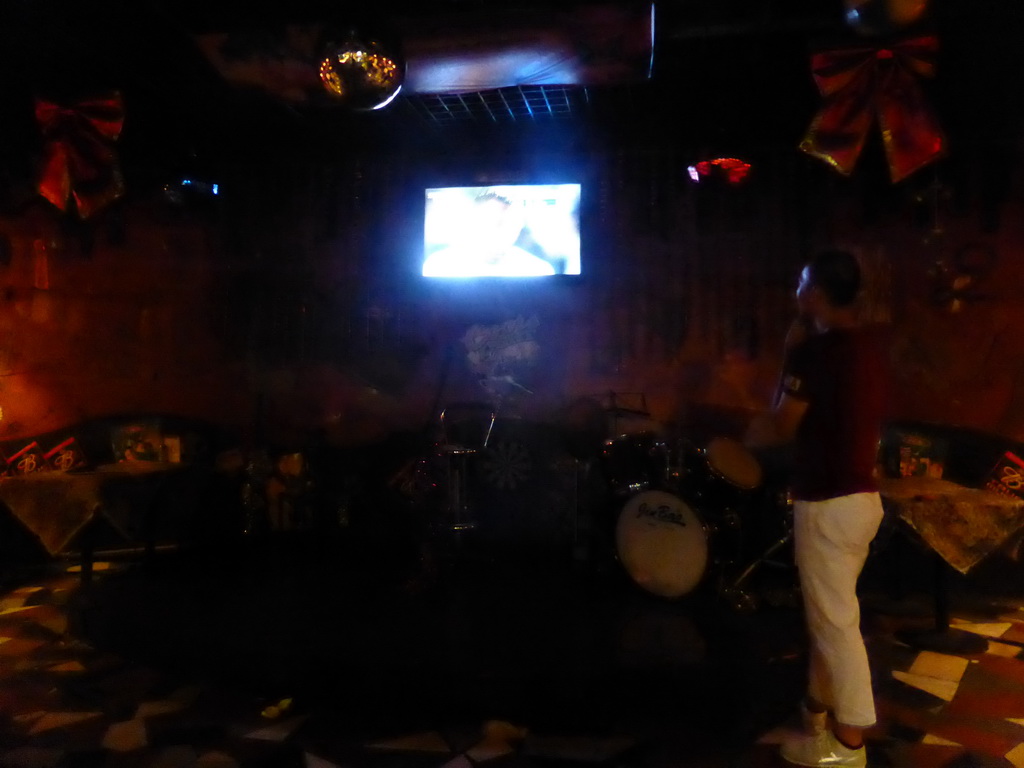 TV screen with the EURO 2016 soccer match Germany vs. Italy and drum set in a pub at Hufang Road