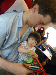 Tim and Max reading a book in the high speed train to Zhengzhou