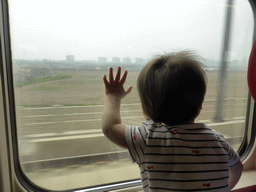 Max looking out of the window of the high speed train to Zhengzhou