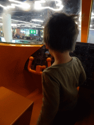 Max in the cockpit of the KLM airplane playground at the Departures Hall of Schiphol Airport